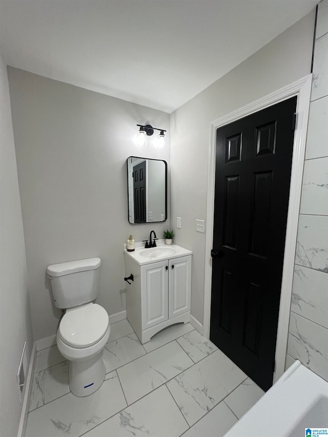 bathroom featuring vanity and toilet