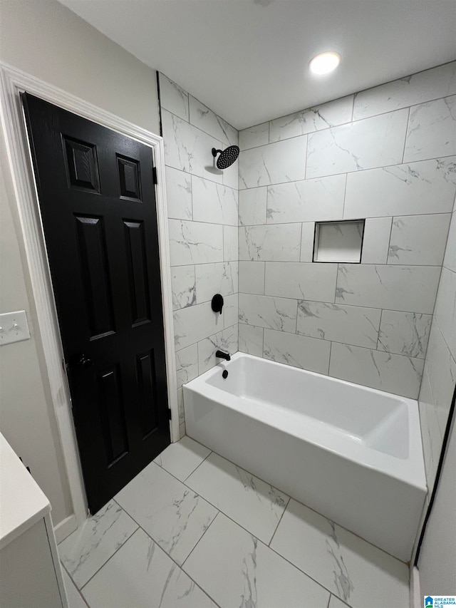 bathroom with vanity and tiled shower / bath