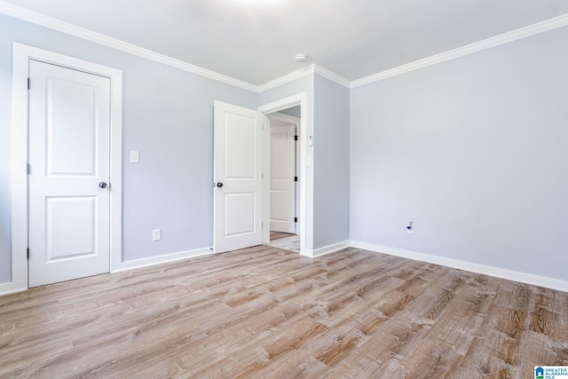 unfurnished bedroom featuring light wood-type flooring and crown molding