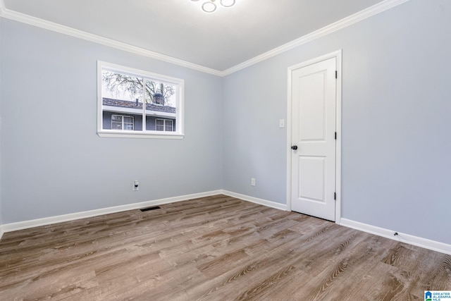 unfurnished room with light hardwood / wood-style flooring and ornamental molding