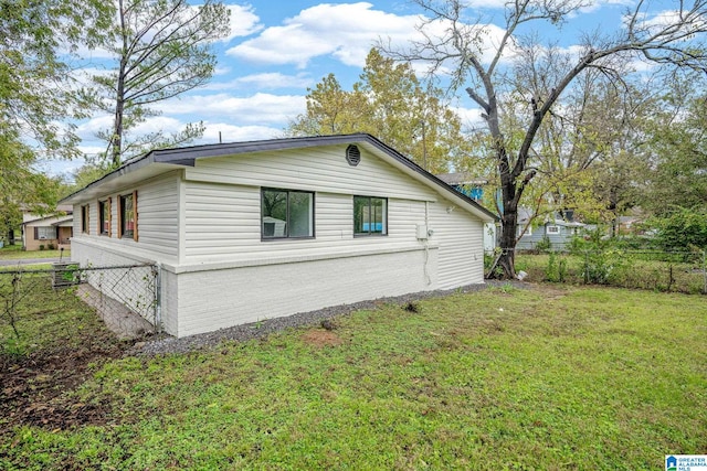 view of side of property with a lawn