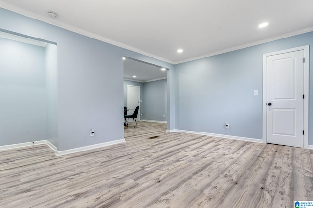 unfurnished room featuring crown molding and light wood-type flooring