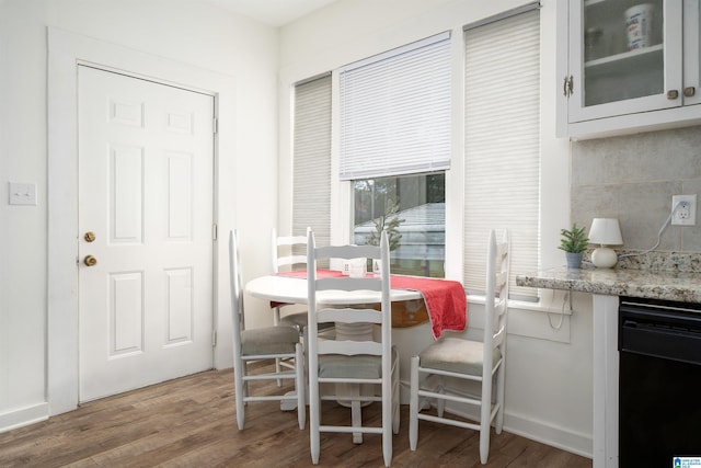 dining area with wood-type flooring and breakfast area