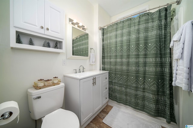 bathroom featuring tile patterned flooring, vanity, toilet, and curtained shower