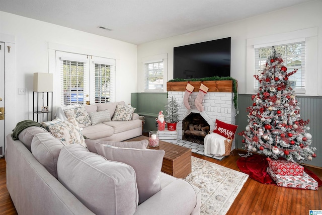 living room with dark hardwood / wood-style flooring and a fireplace