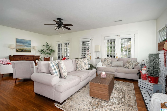 living room with ceiling fan and dark hardwood / wood-style flooring