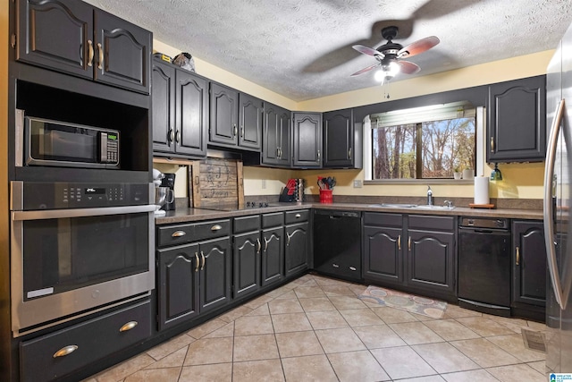 kitchen with a textured ceiling, ceiling fan, sink, black appliances, and light tile patterned floors