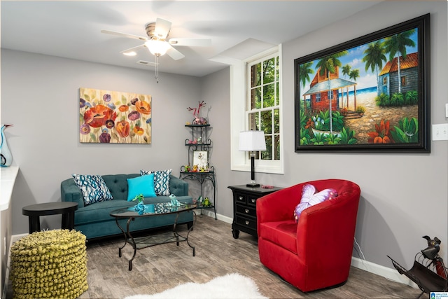 living area with ceiling fan and wood-type flooring