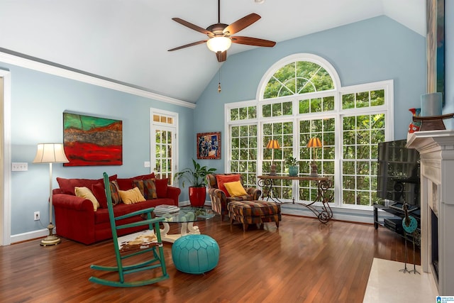 living room featuring baseboards, a fireplace, wood finished floors, high vaulted ceiling, and a ceiling fan