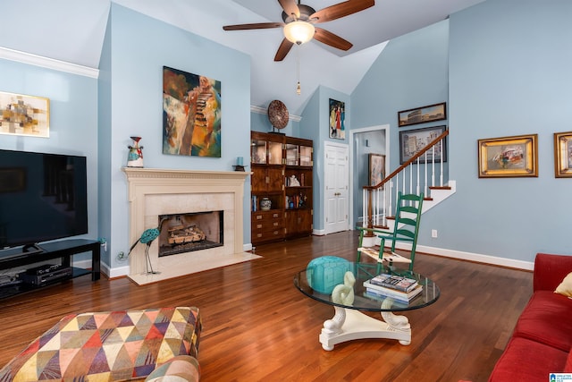 living room with high vaulted ceiling, crown molding, ceiling fan, a premium fireplace, and dark hardwood / wood-style flooring