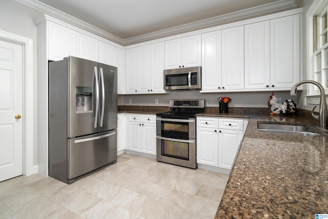 kitchen with appliances with stainless steel finishes, white cabinetry, crown molding, and sink