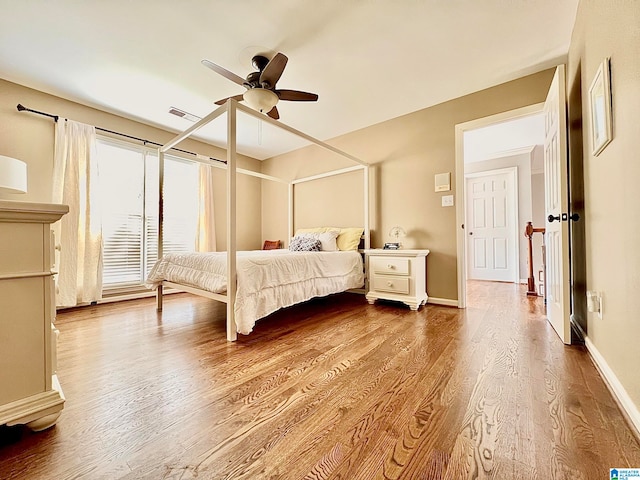 bedroom with ceiling fan and hardwood / wood-style floors