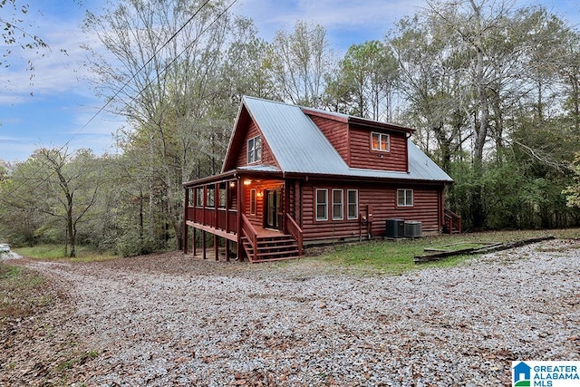 exterior space with central AC unit and a wooden deck