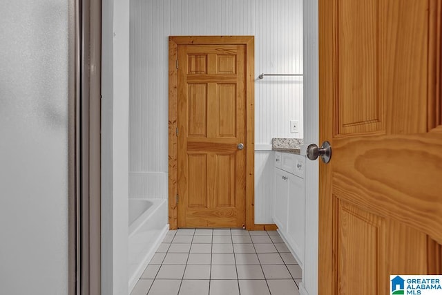 bathroom featuring tile patterned flooring and a bathtub