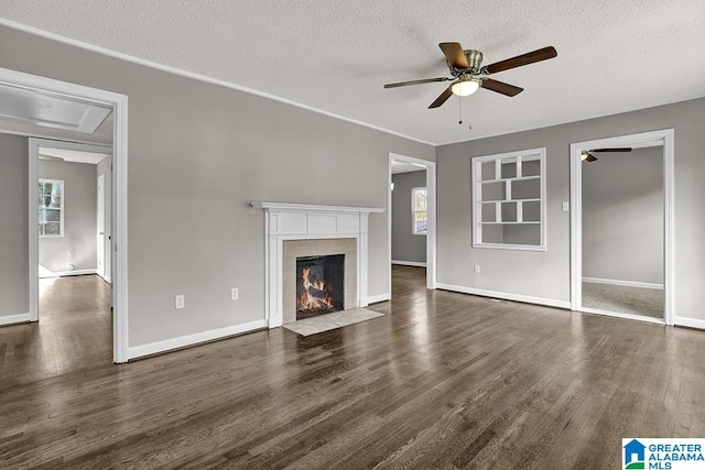 unfurnished living room with a textured ceiling, ceiling fan, and dark hardwood / wood-style floors