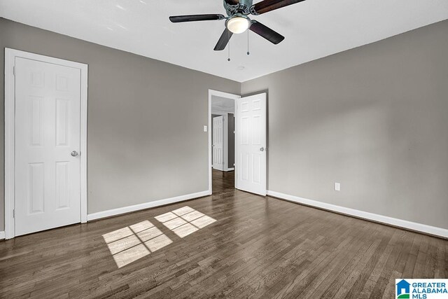 unfurnished bedroom featuring ceiling fan and dark hardwood / wood-style flooring