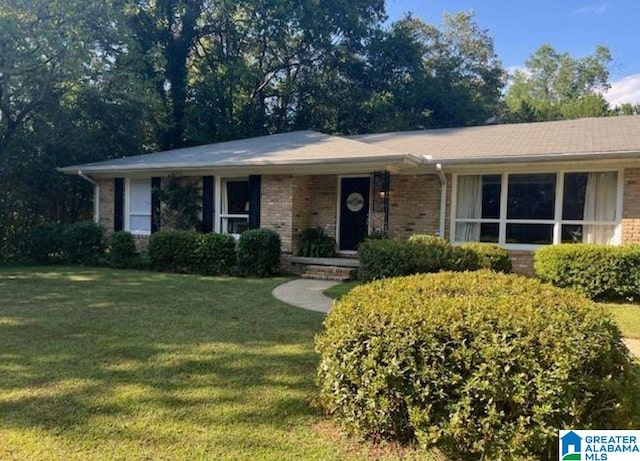 ranch-style home with a front lawn