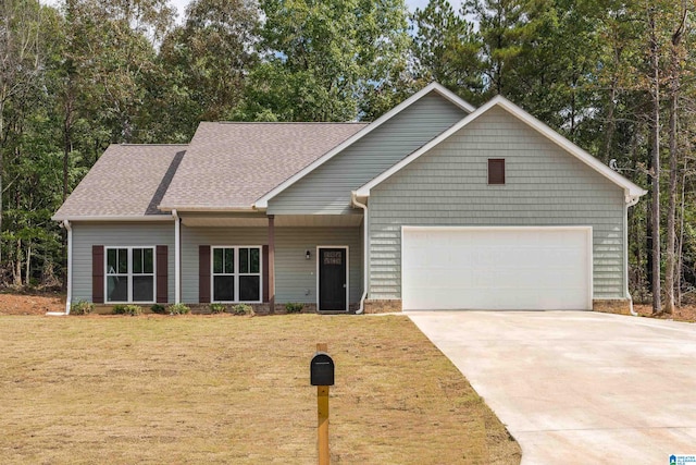 view of front of property featuring a front lawn and a garage