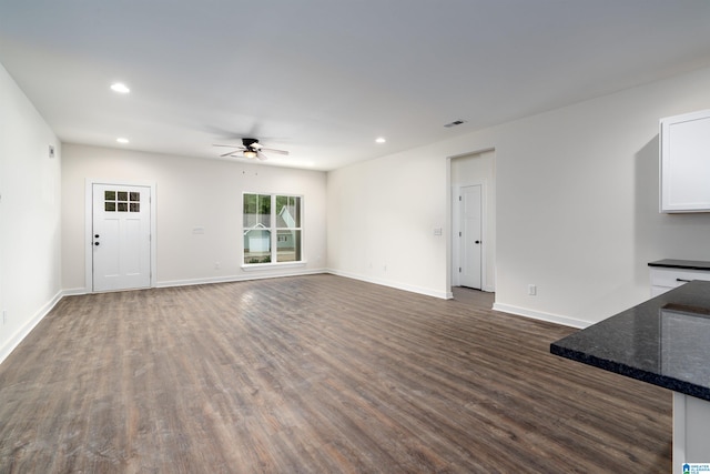 unfurnished living room featuring dark hardwood / wood-style floors and ceiling fan