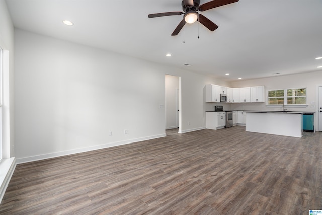 unfurnished living room with hardwood / wood-style floors and ceiling fan