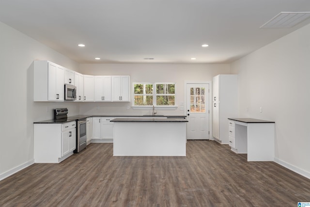 kitchen with white cabinets, dark hardwood / wood-style floors, sink, and stainless steel appliances