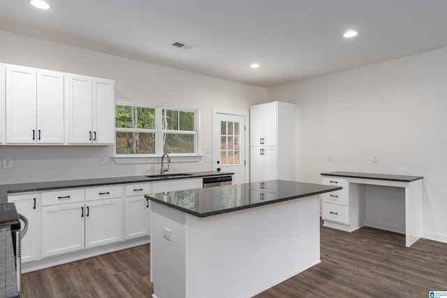 kitchen featuring dark hardwood / wood-style flooring, white cabinetry, sink, and a center island