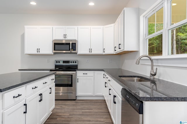 kitchen with sink, white cabinets, and appliances with stainless steel finishes