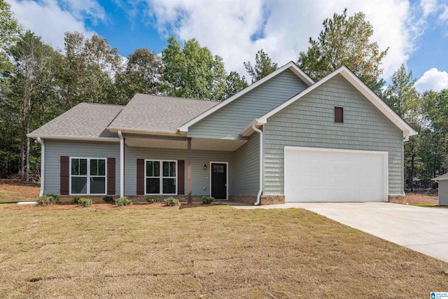 view of front of home with a garage and a front lawn