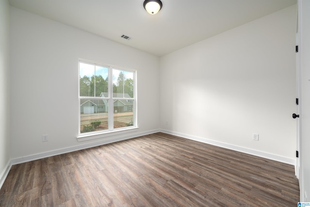 empty room with dark wood-type flooring