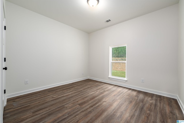 spare room featuring dark hardwood / wood-style flooring