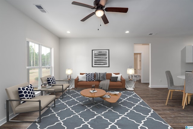 living room featuring ceiling fan and dark hardwood / wood-style flooring