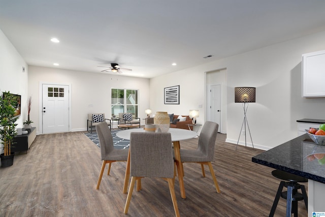 dining space featuring ceiling fan and dark hardwood / wood-style flooring