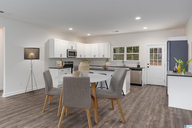 dining area featuring dark hardwood / wood-style floors and sink