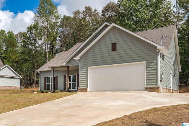 view of front of house featuring a front yard and a garage