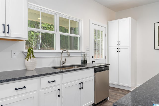 kitchen featuring a wealth of natural light, dishwasher, white cabinets, and sink