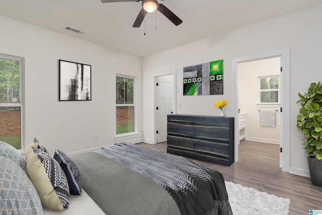 bedroom featuring hardwood / wood-style flooring, multiple windows, and ceiling fan