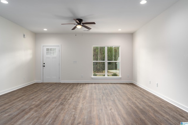 unfurnished room featuring ceiling fan and dark wood-type flooring