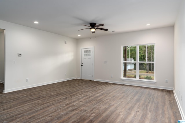 unfurnished room with ceiling fan and dark hardwood / wood-style floors