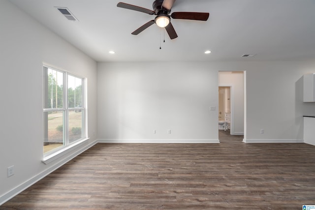 unfurnished room featuring ceiling fan and dark wood-type flooring