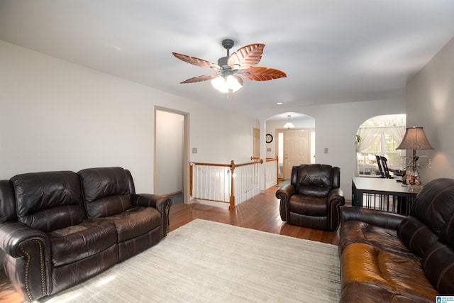 living room featuring ceiling fan and hardwood / wood-style floors