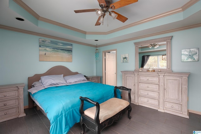 bedroom with ceiling fan, a raised ceiling, and ornamental molding