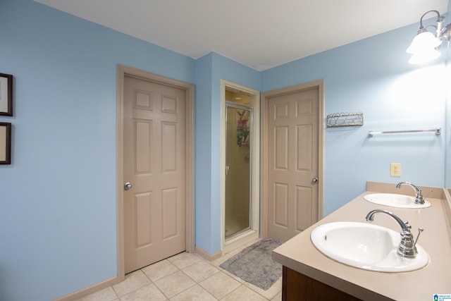 bathroom with tile patterned flooring, vanity, and walk in shower