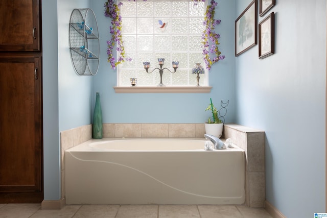 bathroom featuring tile patterned flooring and a bath