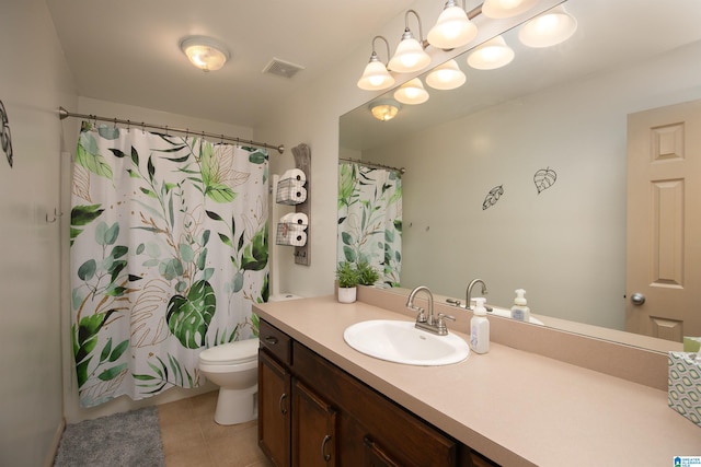 bathroom with tile patterned floors, vanity, toilet, and walk in shower