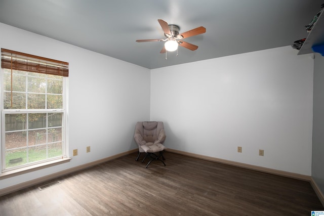 spare room with dark hardwood / wood-style flooring and ceiling fan