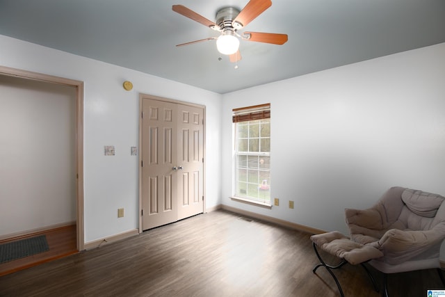 sitting room with wood-type flooring and ceiling fan