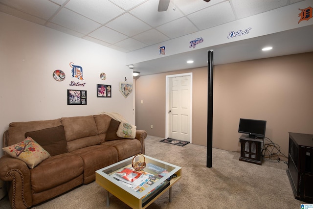 living room featuring carpet flooring, a paneled ceiling, and ceiling fan