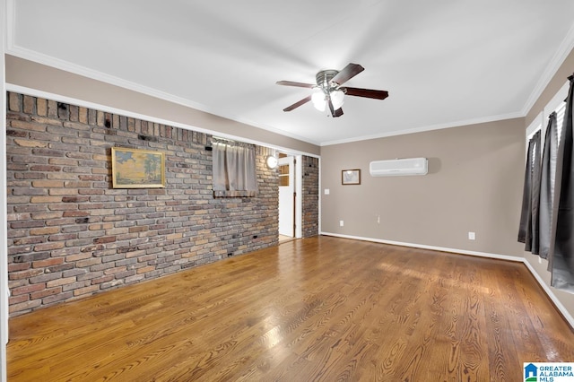 unfurnished living room featuring hardwood / wood-style floors, a wall unit AC, crown molding, and brick wall