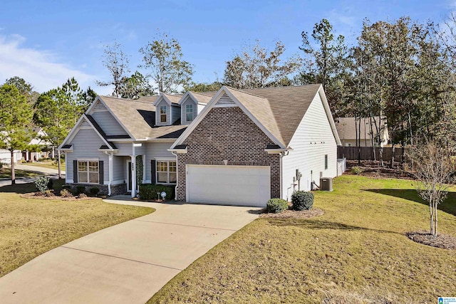 view of front of house with cooling unit, a garage, and a front yard