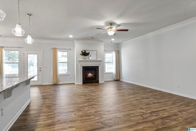 unfurnished living room featuring dark hardwood / wood-style floors, ceiling fan, and crown molding